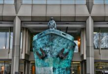 A modern cargo ship sails on the ocean, representing sustainable green shipping solutions.